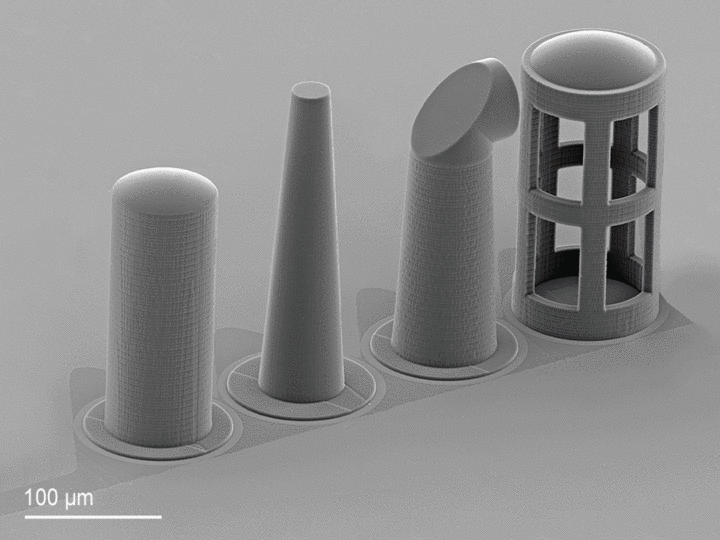Animated GIF of an Array of exemplary freeform microoptics aligned and printed on individual fibers in a v-groove fiber array
