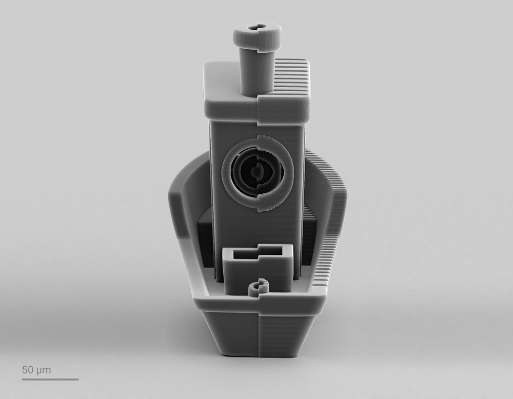 3D printed Benchy boat split into two parts. Left part is 3D printed by 2GL