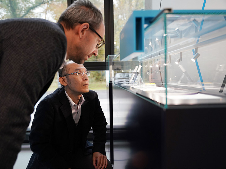 Prof. Shoji Maruo and our CEO Martin Hermatschweiler look at samples on display in our Microfabrication Experience Center