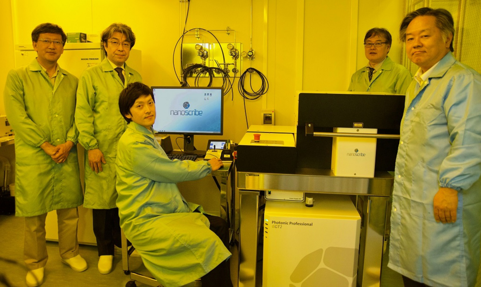 Researchers at Keio University standing at a Nanoscribe Photonic Professional GT2 system