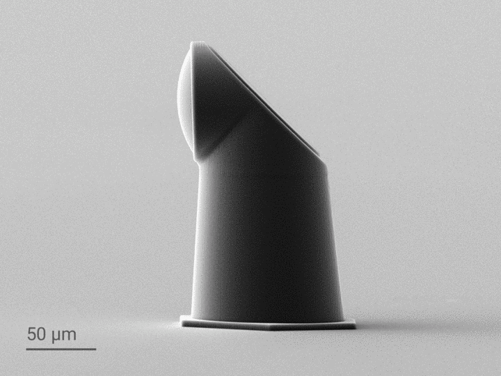 SEM images of 3D-printed periscopic micro-optics on the facet of a V-groove optical fiber array.