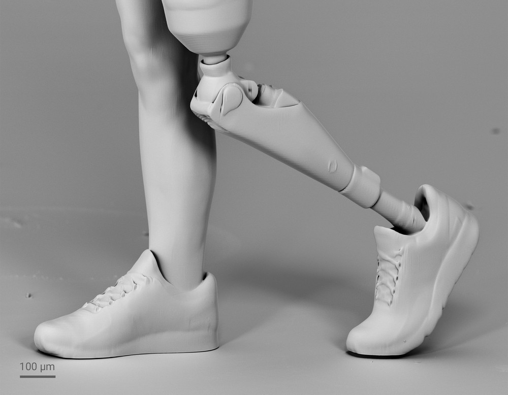 3D printed runner in detail on her legs, one is a prosthetic leg