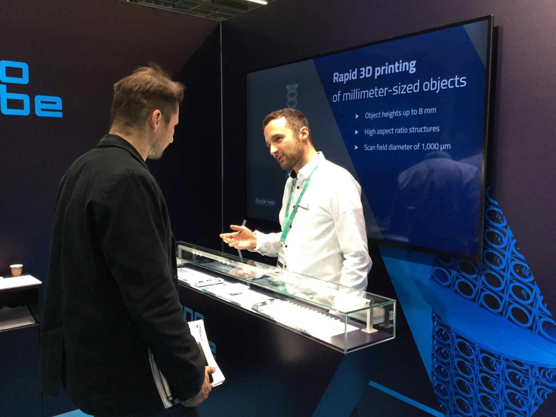 Visitors speaks to Nanoscribe employee at Formnext 2019