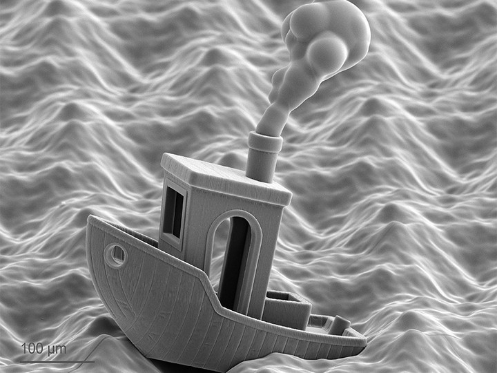 A miniature Benchy model navigating a fully printed wave landscape